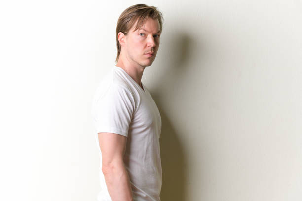 istock Profile view of young handsome man looking at camera 1209199208