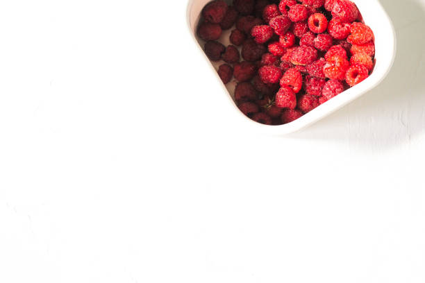 istock White box with raspberries. Raspberries on an isolated background with copy space. 1209199293