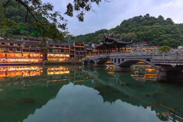 Ancient town Fenghuang at sunset in Hunan China Ancient town Fenghuang at sunset in Hunan China - architecture background fenghuang county photos stock pictures, royalty-free photos & images