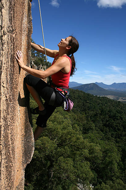 Woman rockclimbing stock photo