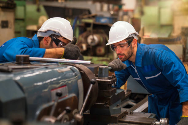 istock Technicians and engineers are working on machines in a factory. Twins Caucasian man Mechanical Engineer checking equipment in the industrial. 1209206818