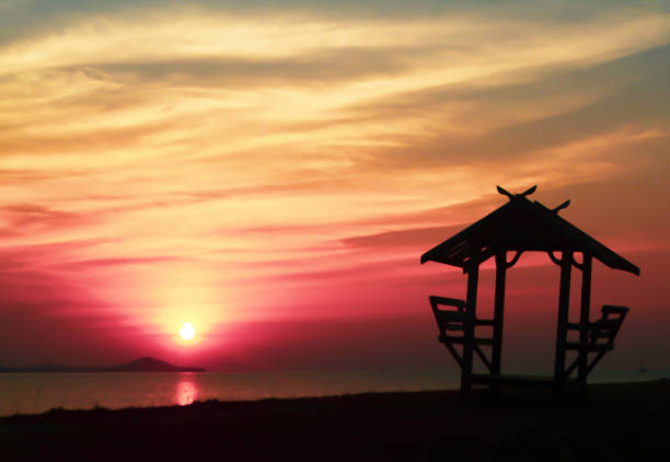 istock beuatiful sunset background with a little hut 1209207174