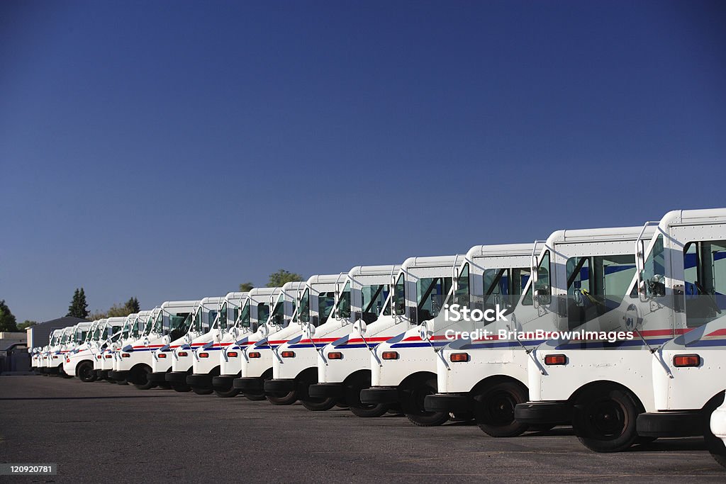 Fleet Vehicles A fleet of US postal service vehicles parked in a line. United States Postal Service Stock Photo