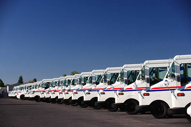 Fleet Vehicles A fleet of US postal service vehicles parked in a line. USPS stock pictures, royalty-free photos & images
