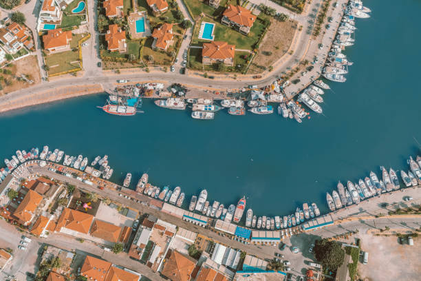 luxury real estate seaside with swimming pool and yachts bird's eye view