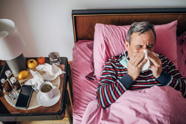istock man has symptoms of virus, has sneezing 1209208289