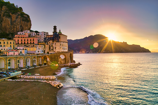 Sunrise over the famous village of Atrani on the Amalfi coast. Many of the small villages along the Amalfi coastline are hundreds of meters above sea level, because of the geographical reasons. The Amalfi coast is a stretch of coastline on the northern coast of the Salerno Gulf on the Tyrrhenian Sea, located in the Province of Salerno of southern Italy. The Amalfi Coast is a popular tourist destination for the region and Italy as a whole, attracting thousands of tourists annually. In 1997, the Amalfi Coast was listed as a UNESCO World Heritage Site.