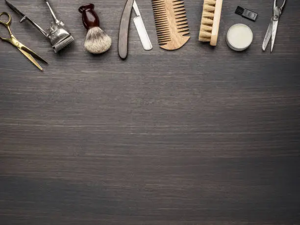 Photo of Classic grooming and hairdressing tools on wooden background.