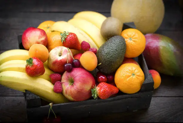 Photo of Fruit in a wooden crate, healthy eating, diet with fresh, organic delicious fruits
