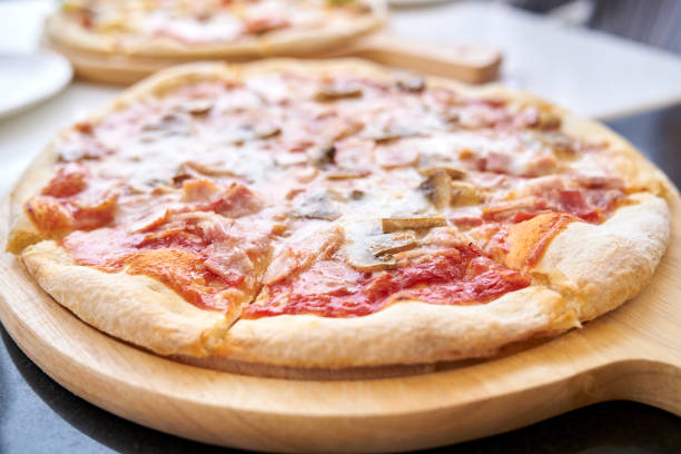 istock pepperoni pizza on wooden board. on the table 1209209932