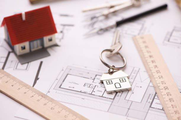 istock A model house on blueprints with keys to the new home. 1209211310