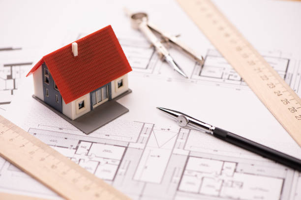 istock A model house on blueprints with keys to the new home. 1209211340
