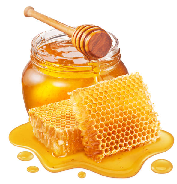 Glass pot of honey, honeycombs and sweet sticky honey puddle isolated on white background. Glass pot of honey, honeycombs and sweet sticky honey puddle isolated on white background. honeycomb pattern photos stock pictures, royalty-free photos & images