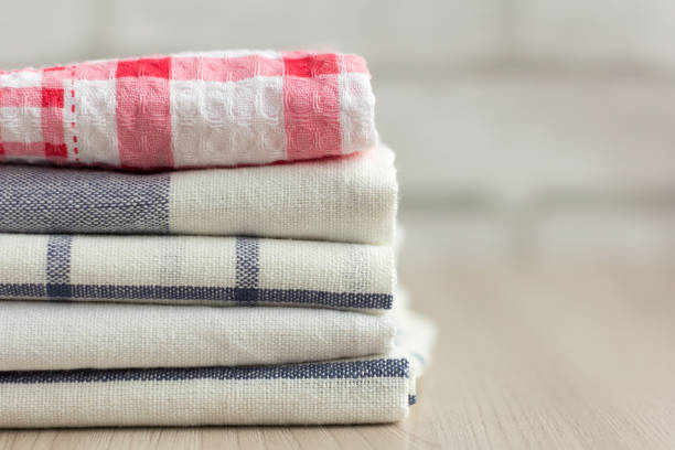 kitchen towels stacked on a light background with a copy of the space