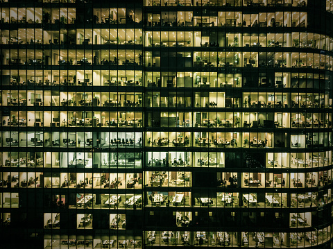 Employees in offices, modern glass office building