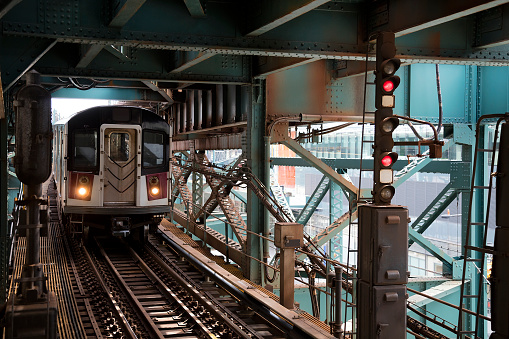 Train approaching elevated subway station in Queens, New York, City.