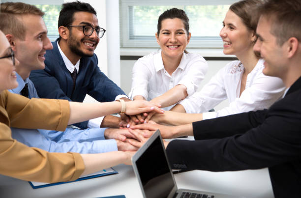 istock International business team showing unity with their hands 1209217337