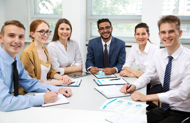 istock Young business people smiling looking at camera 1209218251