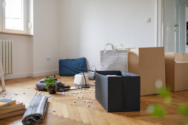 istock Boxes and household items on wooden apartment floor 1209218623