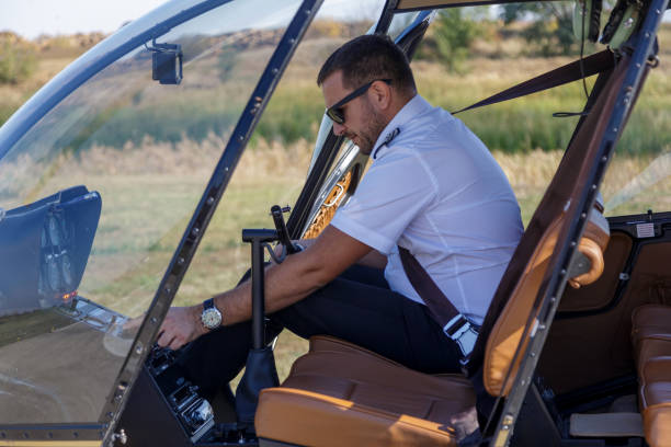 istock Helicopter pilot pushing buttons on navigational equipment 1209218820