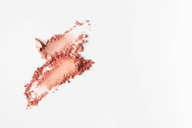 istock Matte blusher smudges on white background with copy space, close-up. Nude tone textured powder eyeshadow, macro. Mineral cosmetic 1209220888