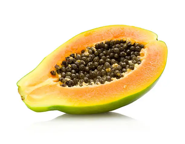 a half of a ripe papaya isolated on white background