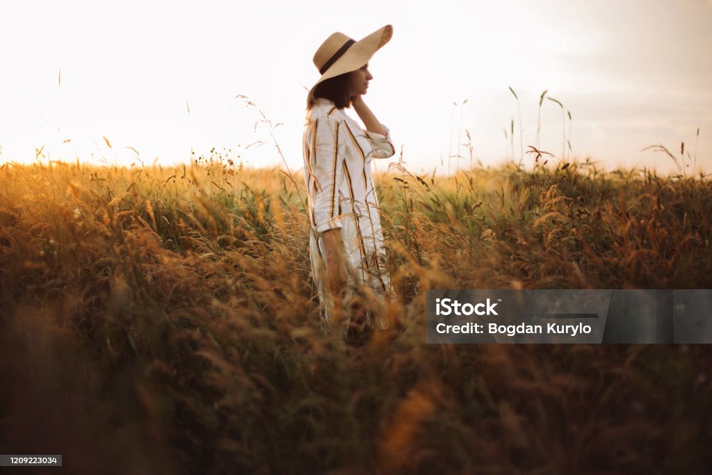 Woman In Rustic Dress And Hat Walking In Wildflowers And Herbs In ...