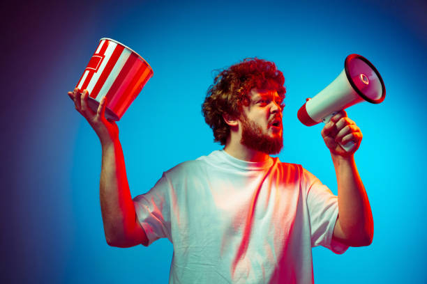 istock Caucasian man's portrait isolated on blue studio background in neon light 1209224825