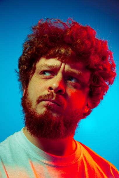 istock Caucasian close up man's portrait isolated on blue studio background in neon light 1209224869