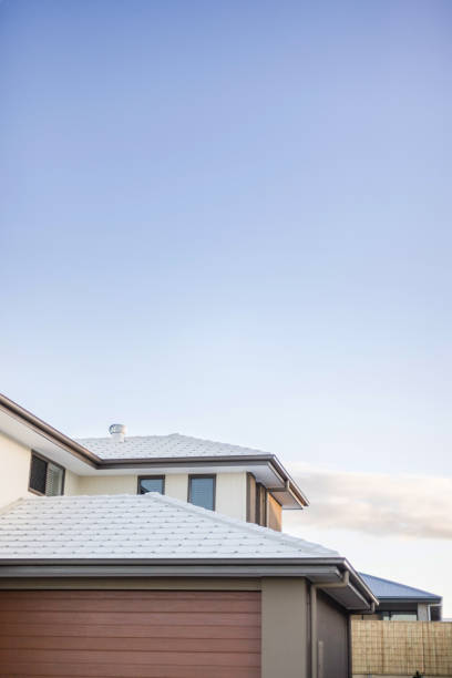 Copy space above a tiled roof of a modern house