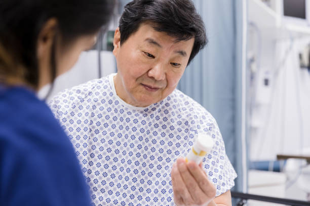 istock Senior man holds medication given to him in emergency room 1209225837