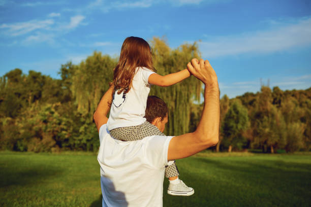 istock Father playing and carrying his daughter on shoulders. 1209228377