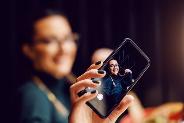 istock Young attractive girl taking selfie while sitting in restaurant on lunch break. 1209231223