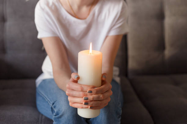 istock woman holding burning candle in her hands 1209231407