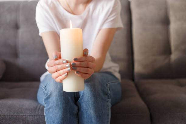 istock woman holding burning candle in her hands 1209231409