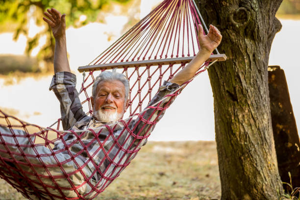 istock Caucasian Senior man lying on hammock in a pine forest. Outdoors relaxation. 1209232270