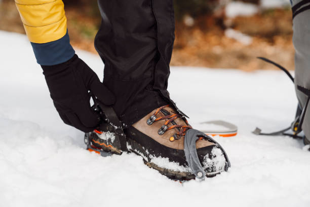 istock Man putting on crampons in the snow 1209233496