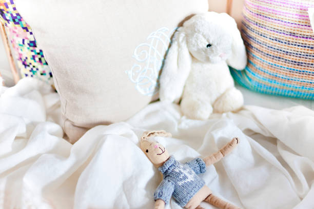 istock Rabbit toys on a bed with pillows closeup 1209233727