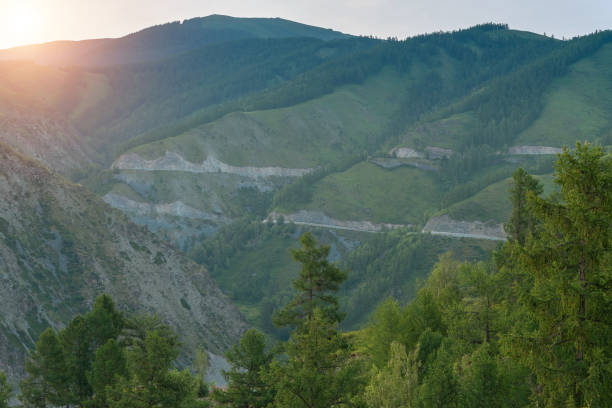 istock Beautiful sunrise against green mountain ranges with valley forest 1209234492