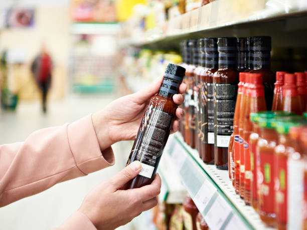 Culinary sauce in hand buyer at store Culinary sauce in the hand of the buyer in the store condiment stock pictures, royalty-free photos & images