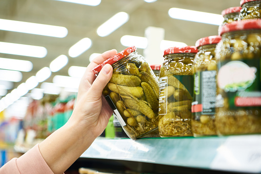 Pickled cucumbers in a jar in a store