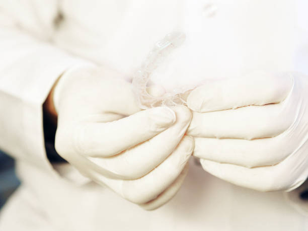 istock Dentist holding a silicone trainer, dental aligner 1209236954