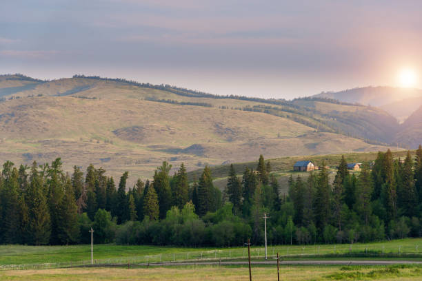 istock Sunrise landscape with log cabin and forest 1209237392