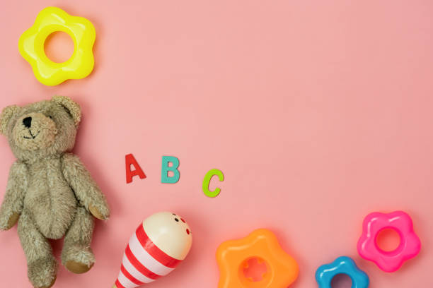 istock Table top view decoration kid toys for develop background concept.Flat lay accessories baby the doll bear with object on modern pink paper at office desk.Copy space for add text.pastel tone wallpaper. 1209238772