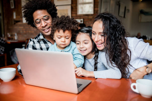 istock Happy multiethnic family having fun while using laptop together 1209238885