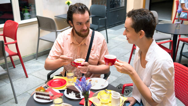 istock Couple chatting in a summer cafe at breakfast 1209240760