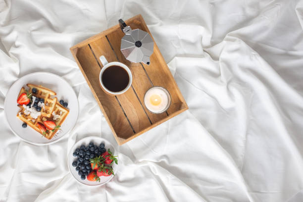 istock Beautiful breakfast in bed: Viennese Belgian waffles decorated with berries, a plate with strawberries and blueberries 1209241449