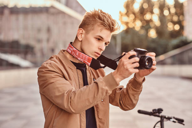 istock Man with scooter and proto camera is taking photos 1209241468