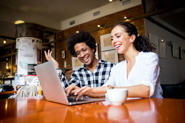 istock Multiethnic business team meeting at cafe, working using laptop 1209242186