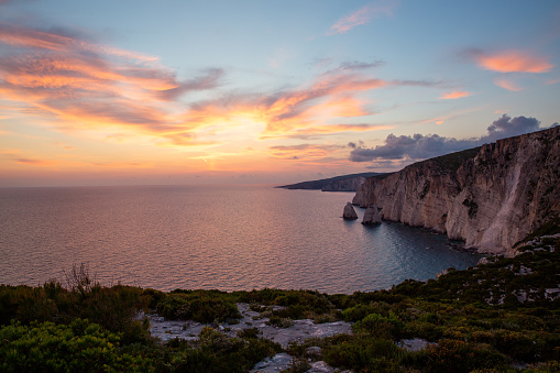 Greece, Zakynthos, Silent ocean water alongside giant cliffs at islands seaside near agalas